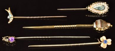 Two Victorian stick pins, one set with seed pearls and jet, the other with agate and seed pearl, two