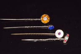 Four 9ct gold Victorian stick pins set with paste, all in antique boxes