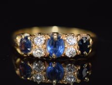 A c1920 18ct gold ring set with three sapphires and diamonds, 4g, size R