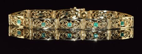 An 18ct gold bracelet made up of pierced rectangular links each set with emeralds, length 18.5cm,