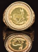 A 9ct gold ring set with a 1985 gold 1/10 Krugerrand, 7.9g, size T