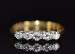 An 18ct gold ring set with five diamonds in a platinum setting, 3.0g, size N