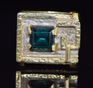 A 1970s 18ct gold ring set with a quartz in a raised rectangular mount, with textured surface to the