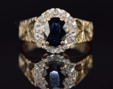 A 9ct gold ring set with a sapphire and diamonds, 3.6g, size N