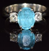An 18k white gold ring set with an oval cut topaz and two diamonds, each approximately 0.15ct