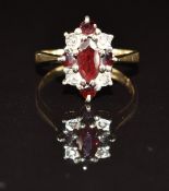A 9ct gold ring set with a marquise and round cut garnets and diamonds, 3.1g, size N