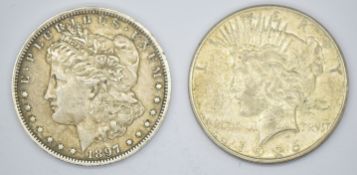 1897 Morgan US silver dollar and a 1926 Liberty / Peace dollar