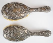 Pair of Victorian hallmarked silver brushes with embossed decoration, Birmingham 1895, maker Henry