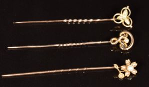 Edwardian 15ct gold stick pin (1.2g) and two Edwardian 9ct gold stick pins, all set with seed pearls