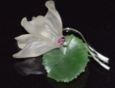 A 14k white gold brooch in the form of a lily set with nephrite jade, quartz, rubies and a