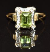 A 9ct gold ring set with an emerald cut peridot and diamonds, 2.0g, size K