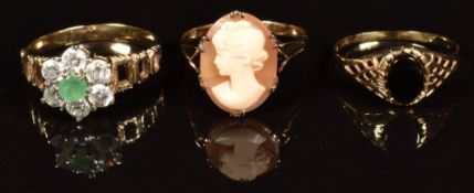 Three 9ct gold rings, one set with an emerald surrounded by cubic zirconia, one with a cameo and the