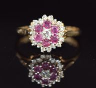 A 9ct gold ring set with rubies and diamonds in a cluster, 2g, size L