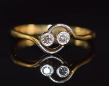 An 18ct gold ring set with two diamonds in a platinum twist setting, 2.0g, size I/J