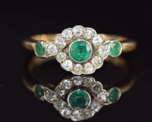 A c1915 18ct gold ring set with three emeralds and old cut diamonds diamonds, 3.0g, size O