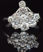 An 18ct white gold ring set with a cluster of old cut diamonds, largest 0.28ct, 4.6g, size N