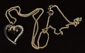 A 9ct white gold pendant in the form of a heart set with diamonds, totalling approximately 0.15ct,