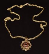 A 9ct gold pendant set with garnets, on a 9ct gold chain, length 44cm, weight of both 7.4g