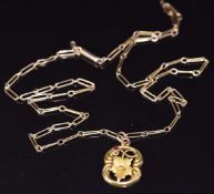 Art Nouveau 9ct gold pendant set with a garnet, on 9ct rose gold chain with barrel clasp, 3g