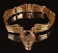 A c1900 9ct rose gold gate bracelet with engraved bars and heart padlock charm, 26.7g