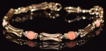 A 9ct gold bracelet set with five coral cabochons, 13.9g