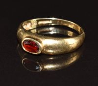 A 9ct gold ring set with an oval cut garnet, 2.6g, size P