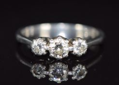 A platinum ring set with three diamonds, the centre diamond approximately 0.3ct, 4.4g, size L
