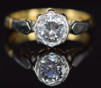 An 18ct gold ring set with a 0.8ct round cut diamond in a platinum setting, 3.4g, size J