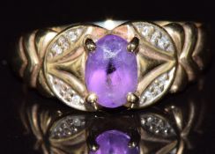 A 9ct gold ring set with an oval cut amethyst and diamonds, 2.3g, size P