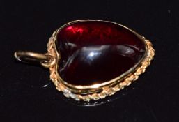 Victorian pendant set with a heart cut foiled garnet within a rope twist border, 3.9g, 1.6 x 1.4cm