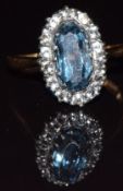 An 18k gold ring set with a topaz and white sapphires, 2.4g, size M