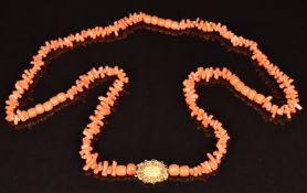 A beaded 19thC coral necklace with yellow metal clasp