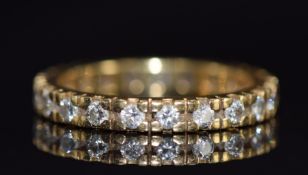 An 18ct gold eternity ring set with twenty round cut diamonds, 3.3g, size L/M