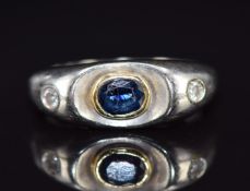 An 18ct white gold ring set with a sapphire and diamonds, 4.5g, size M