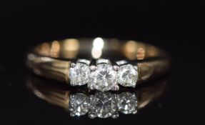 A 9ct ring set with three diamonds, the centre diamond approximately 0.2ct, 2.9g, size O