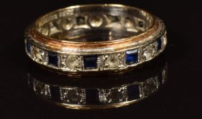 A 9ct gold eternity ring set with sapphires and paste. 3.2g