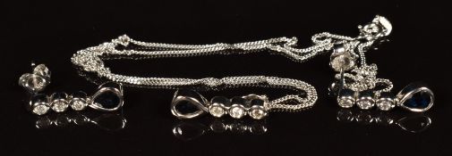 A 9ct white gold pendant set with a pear cut sapphire and diamonds, on 9ct gold chain with