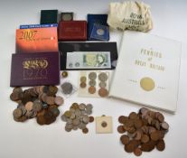 A collection of UK pennies in an album, together with coin sets and loose copper examples, a
