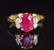 A 14k gold ring set with an oval cut ruby and four diamonds, 3.4g, size O