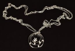 An 18ct white gold concentric circles pendant set with diamonds, on 18ct white gold double chain,