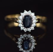 A 9ct gold ring set with a sapphire surrounded by cubic zirconia, 3.2g, size Z