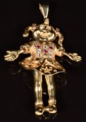 A 9ct gold articulated pendant in the form of a girl, set with synthetic rubies and cubic
