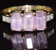 A 9ct gold ring set with three amethysts and topaz, 2.6g, size N