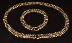A 14k gold tri-coloured necklace and matching bracelet made up of oval links, lengths 45 and 20.5cm,