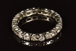 An 18ct white gold eternity ring set with 21 diamonds, each approximately 0.05ct (one diamond