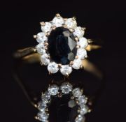 A 9ct gold ring set with a sapphire surrounded by cubic zirconia, 2.1g, size P