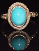 A 9ct rose gold ring set with a cabochon, with engraved decoration to the band and setting,