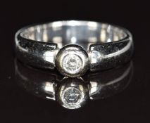 An 18ct white gold ring set with a diamond of approximately 0.1ct, 5g, size M