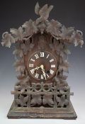 Late 19th or early 20thC mantel or bracket cuckoo clock with carved leaf borders and pediment,