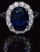 An 18ct white gold ring set with an natural oval cut sapphire measuring approximately 4ct surrounded